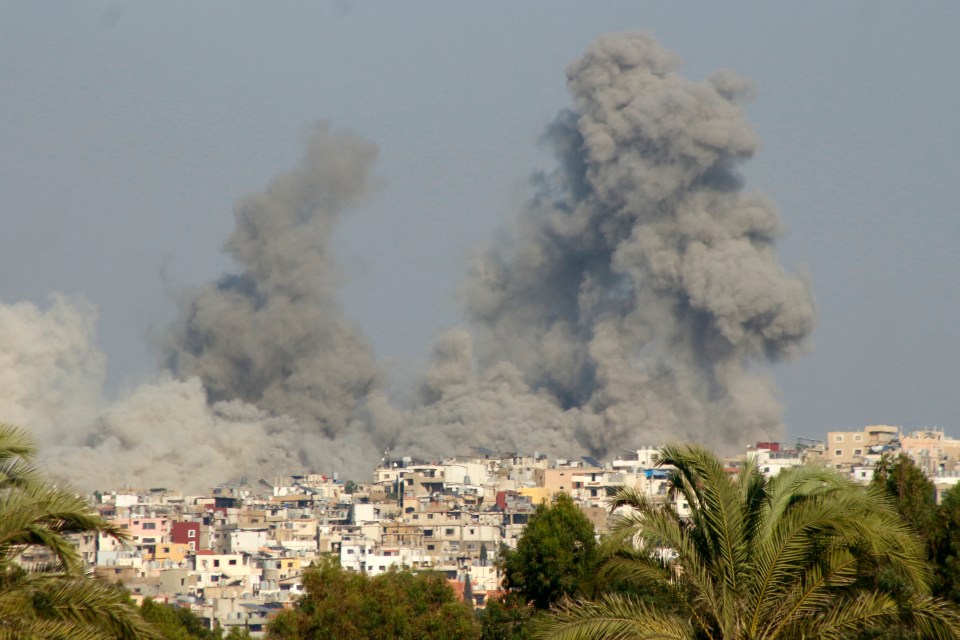 a large cloud of smoke is coming out of a building