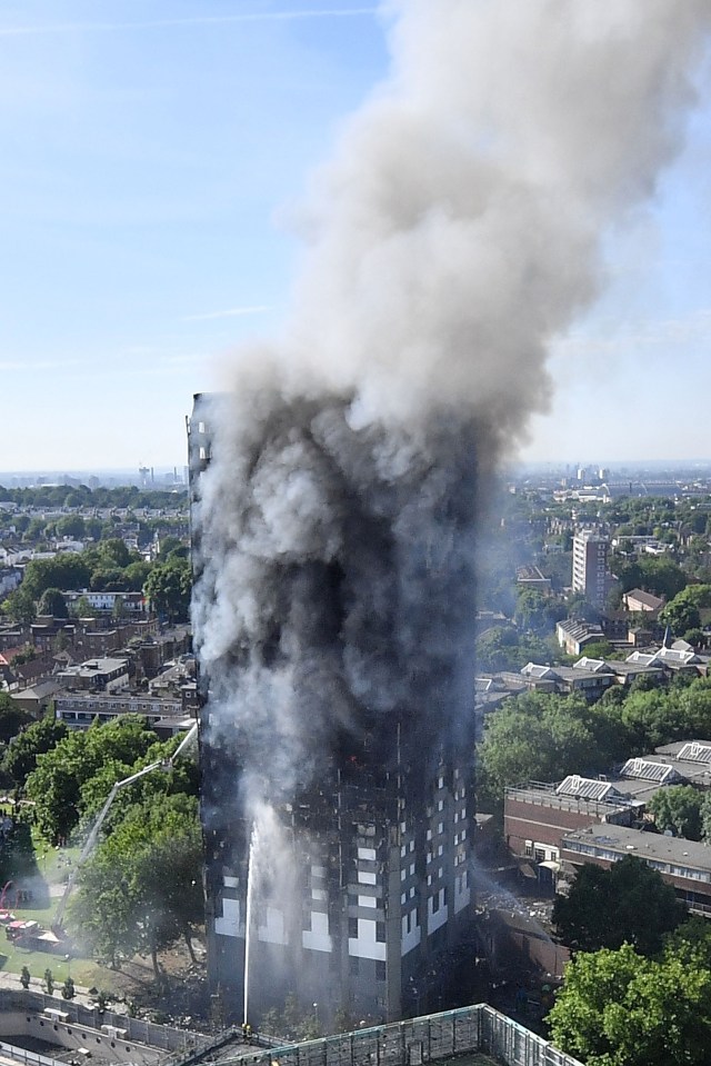 smoke is coming out of a building that has the letter t on it