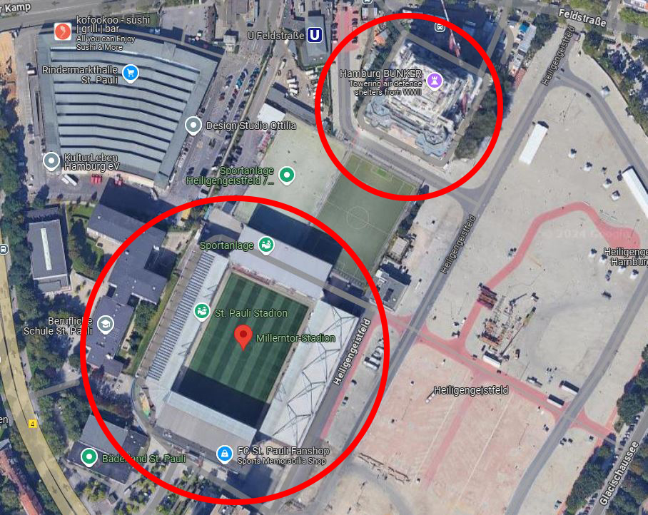 an aerial view of a soccer stadium with a red circle around it