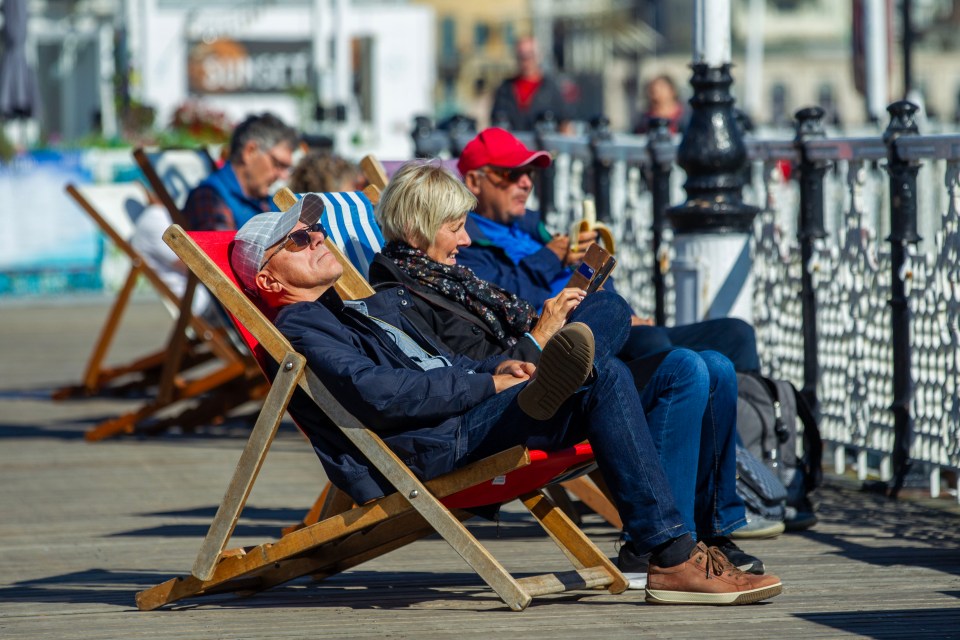 Sun worshippers make the most of relaxing in deckchairs on the Palace Pier in Brighton  on Friday