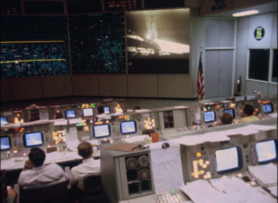 a control room with a clock on the wall that says ' a ' on it