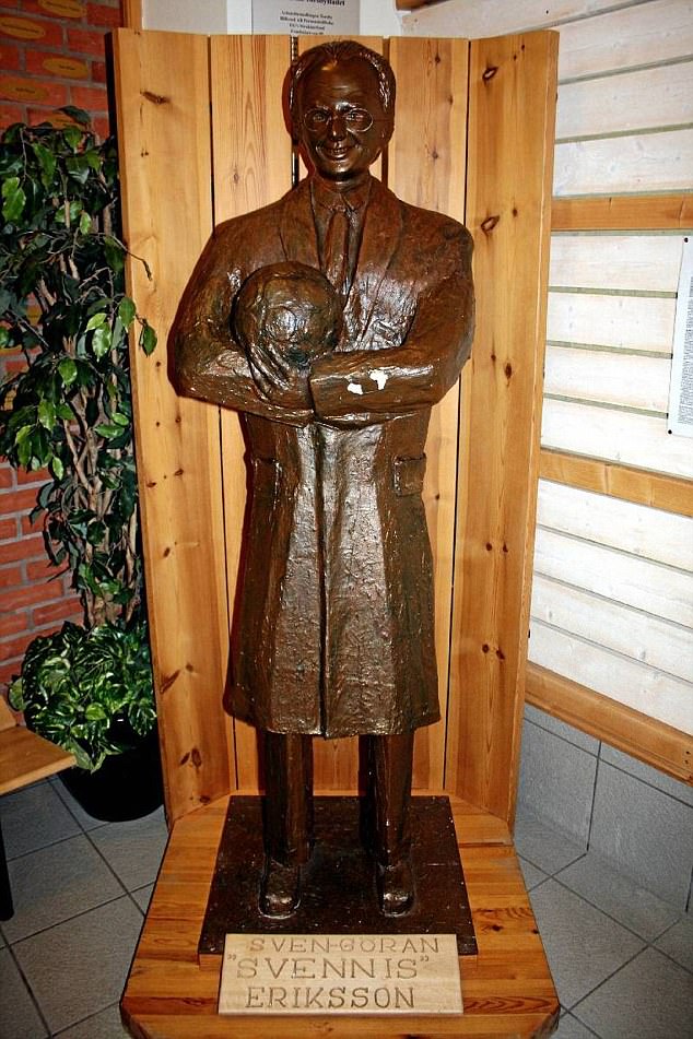 a bronze statue of svenn eriksson holding a soccer ball