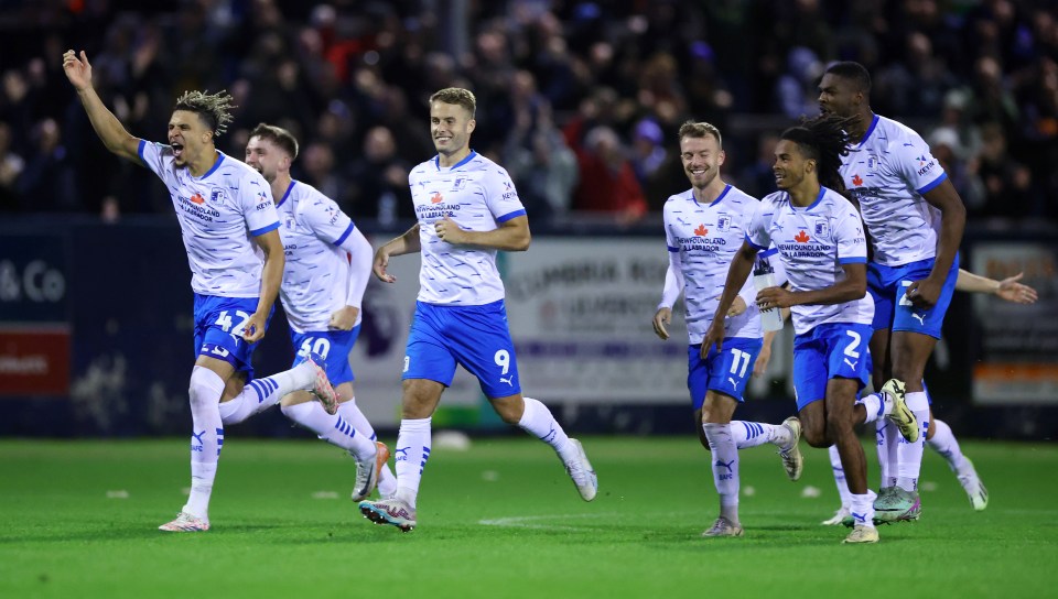 a group of soccer players wearing blue and white jerseys with the number 9 on them