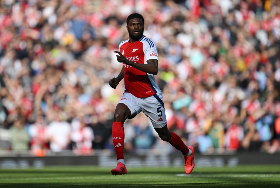 a soccer player wearing a jersey that says emirates on it