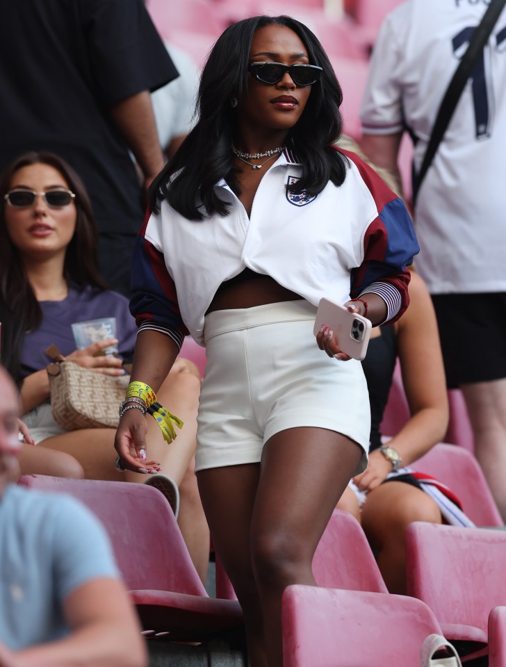 a woman wearing shorts and a shirt with the word england on it