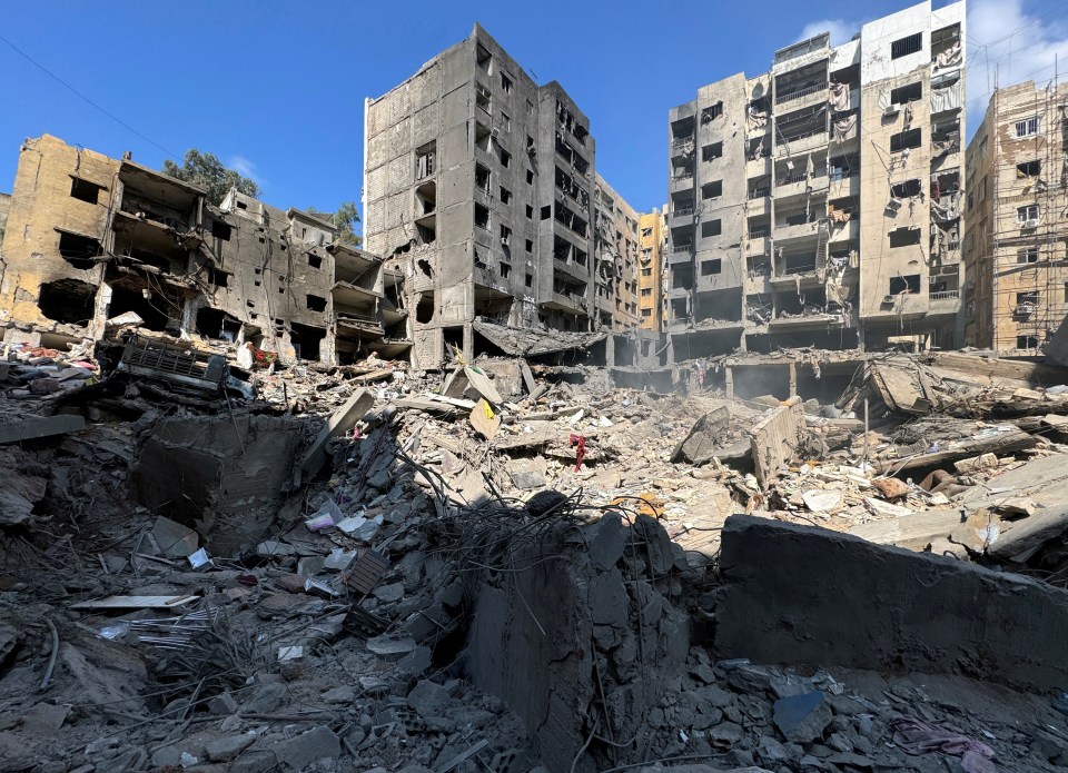 a pile of rubble in front of a building that has been demolished