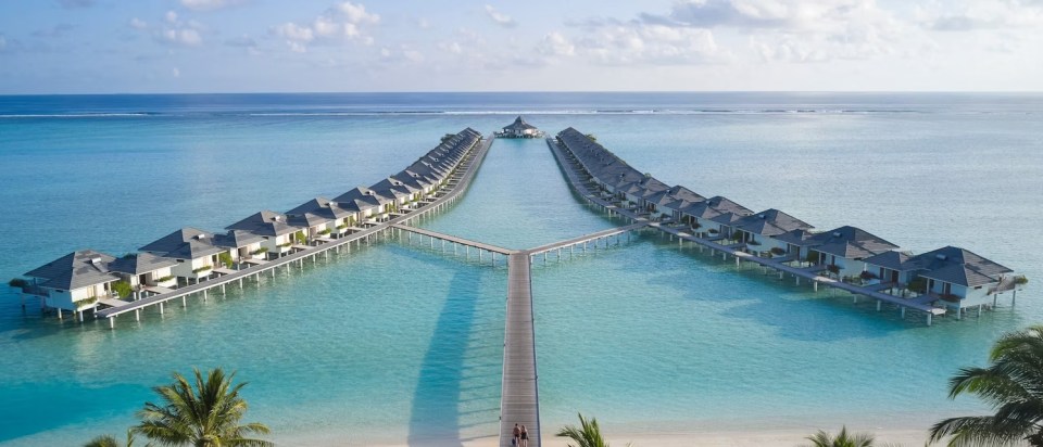 The resort has water bungalows overlooking a crystal clear ocean teeming with fish