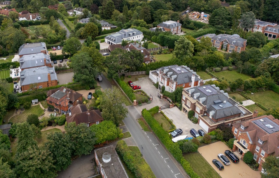 an aerial view of a residential area with houses and a tennis court