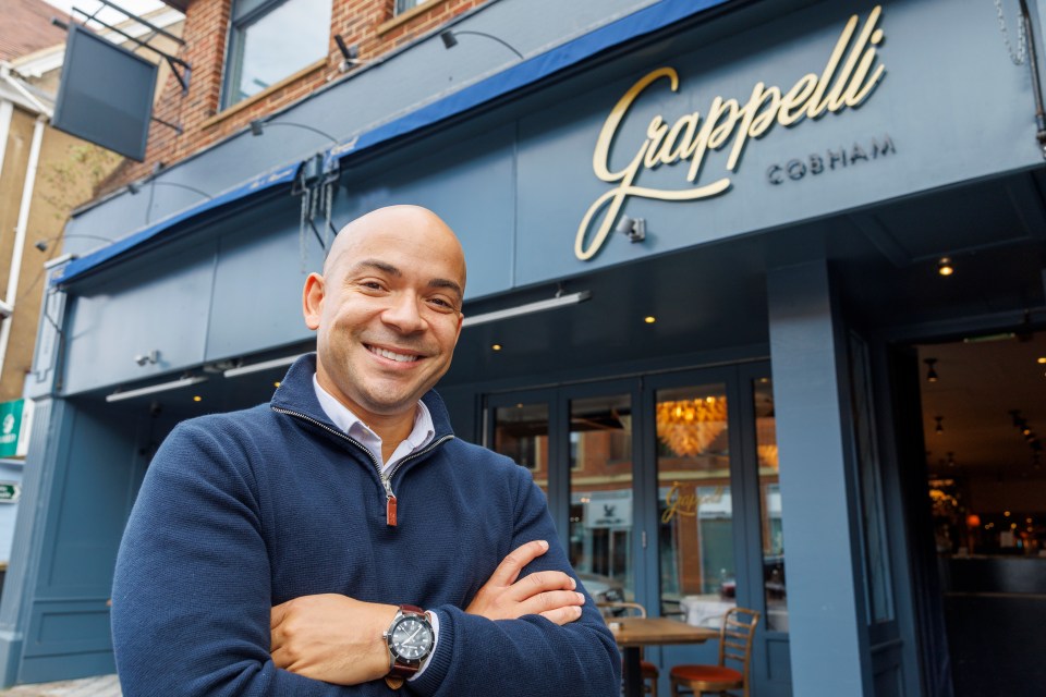 a man stands in front of the grappelli cobham restaurant