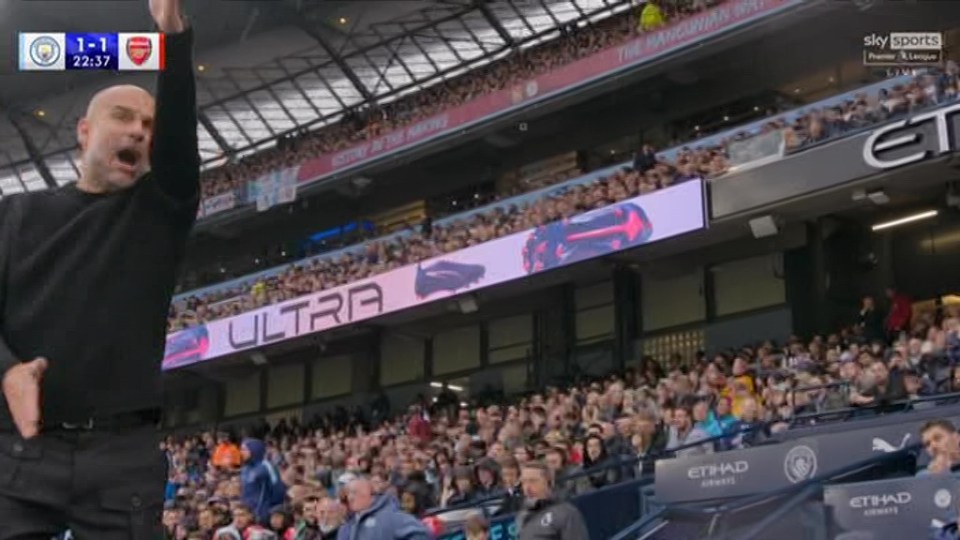 a man stands in front of a large screen that says ultra