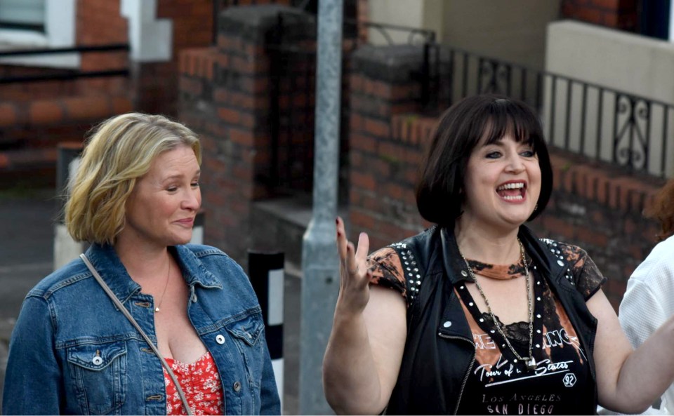 a woman wearing a los angeles shirt laughs with another woman