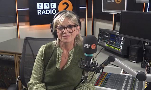 a woman is sitting in front of a microphone in a radio studio .