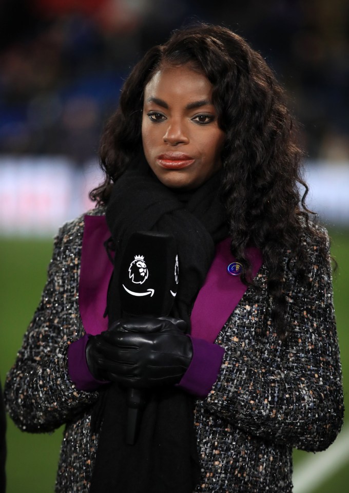 a woman wearing a purple jacket and black gloves holds a black item with an amazon logo on it