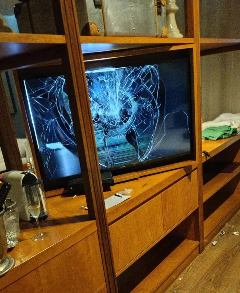 a broken sony tv is sitting on a wooden shelf