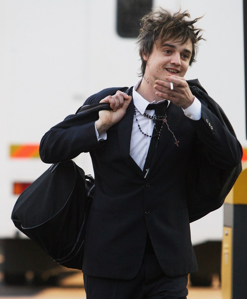 a man in a suit and tie carrying a large black bag