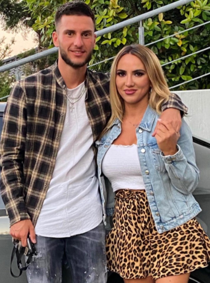 a man in a plaid shirt stands next to a woman in a leopard print skirt