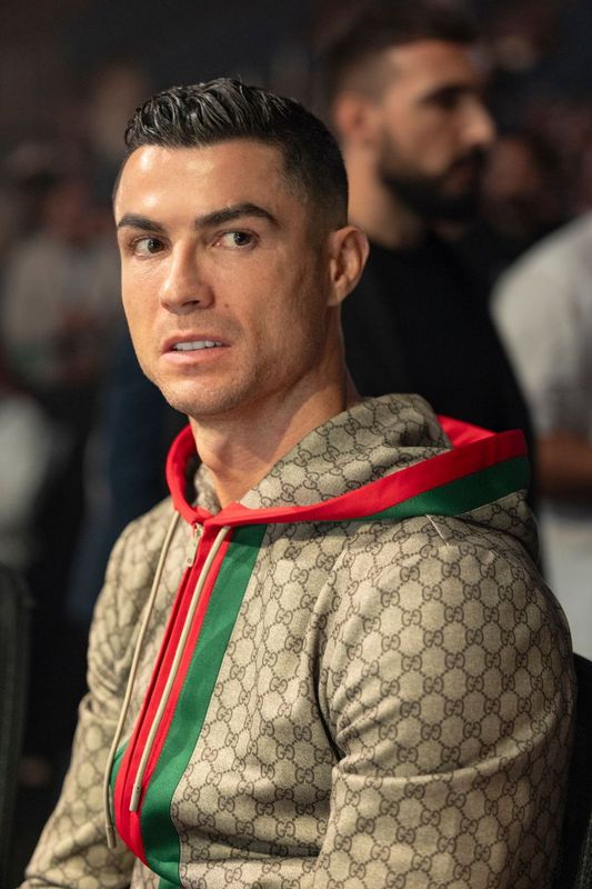 a man wearing a gucci hoodie looks at the camera