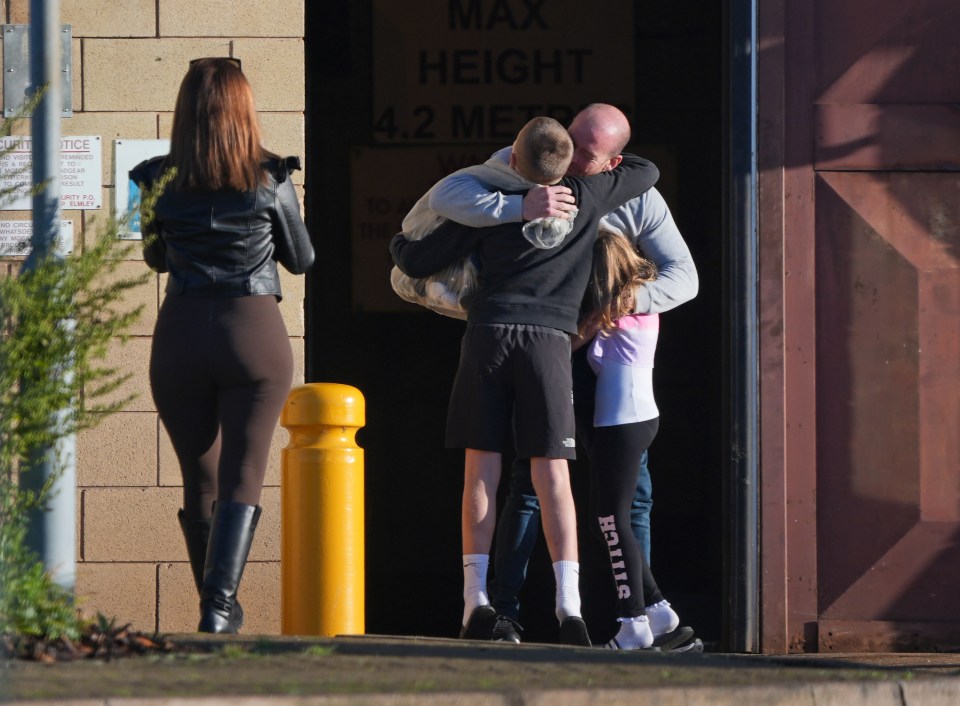 A released prisoner hugs his kids after being released today