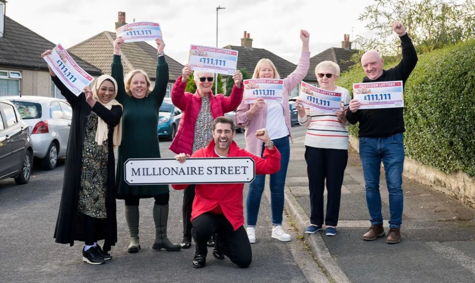 a group of people holding up signs that say millionaire street