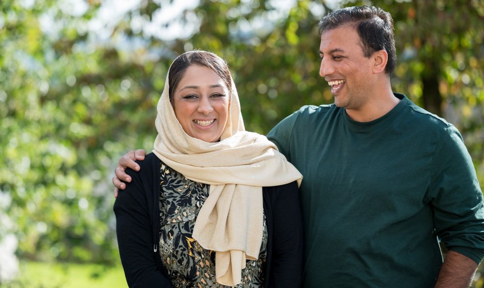 a man and a woman are standing next to each other and smiling