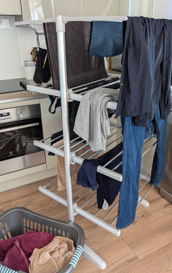 clothes drying on a rack with a basket in the foreground