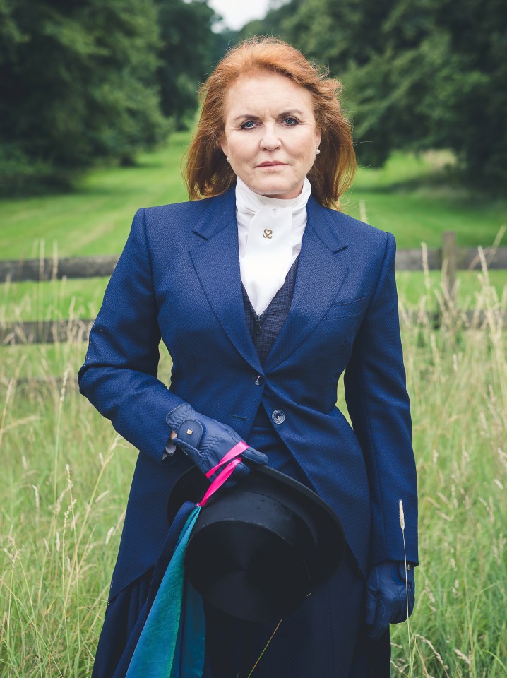 a woman in a blue suit is standing in a field