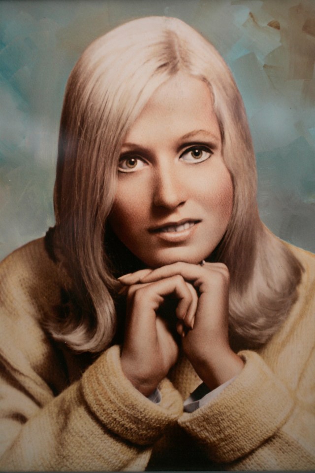 a portrait of a woman with blonde hair and blue eyes