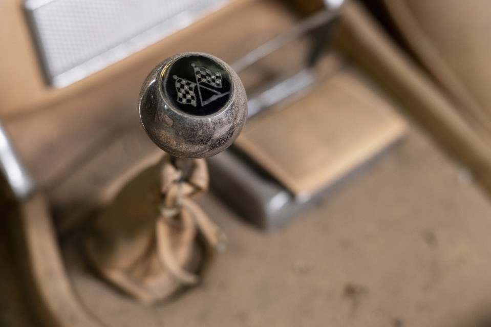 a close up of a car shift knob with a checkered flag on it