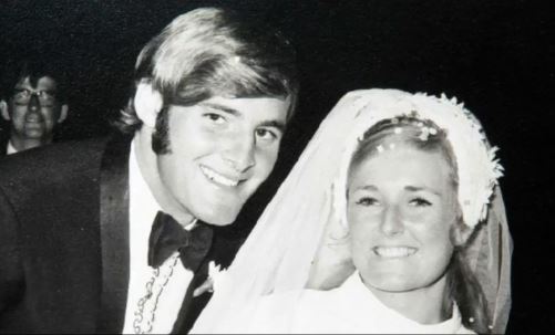 a black and white photo of a bride and groom on their wedding day .