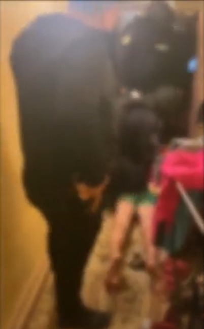 a blurry picture of a man standing next to a woman in a room .