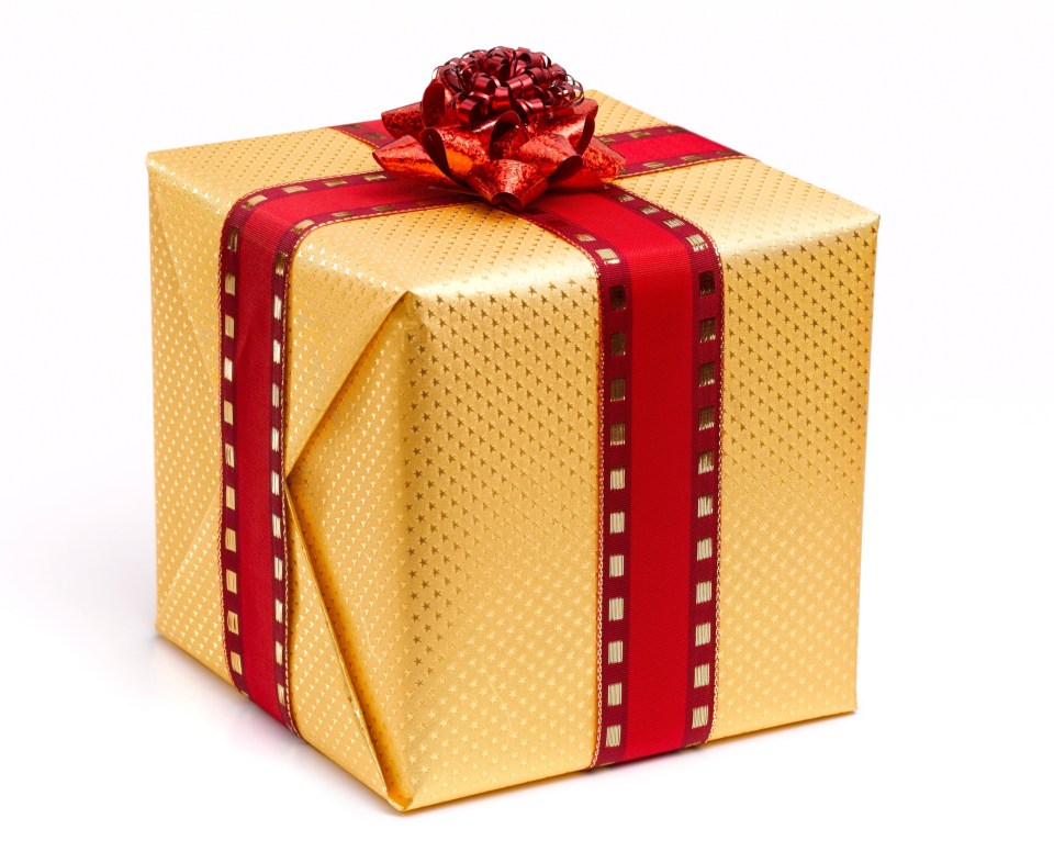 a gold gift box with a red ribbon and bow