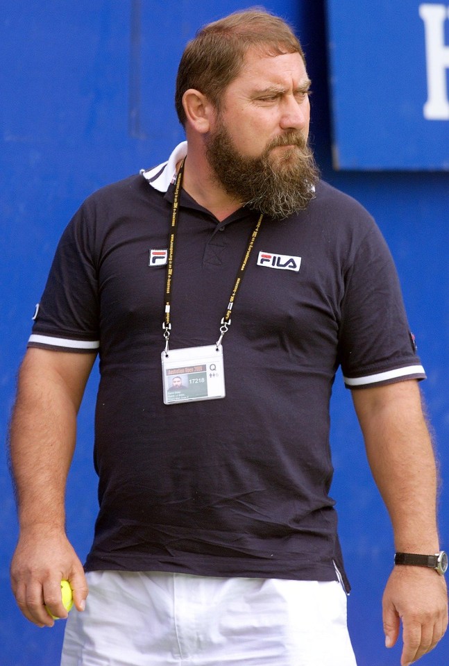 a man with a beard is wearing a fila shirt