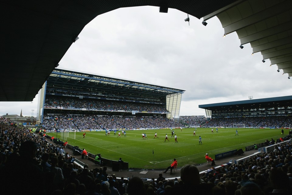 a soccer game is being played in a stadium that has a sign that says ' allianz ' on it