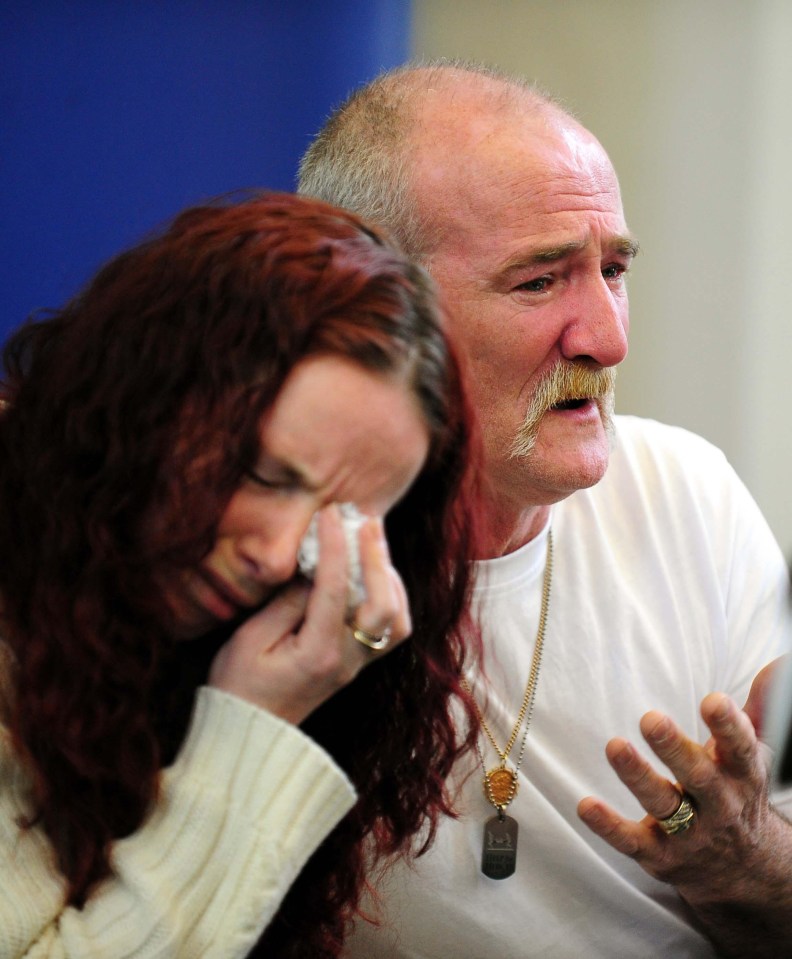 a man with a mustache is talking to a woman who is crying