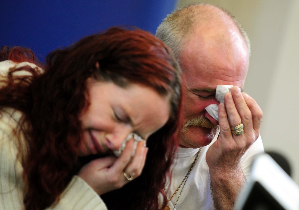 a man and a woman wipe their eyes with tissues