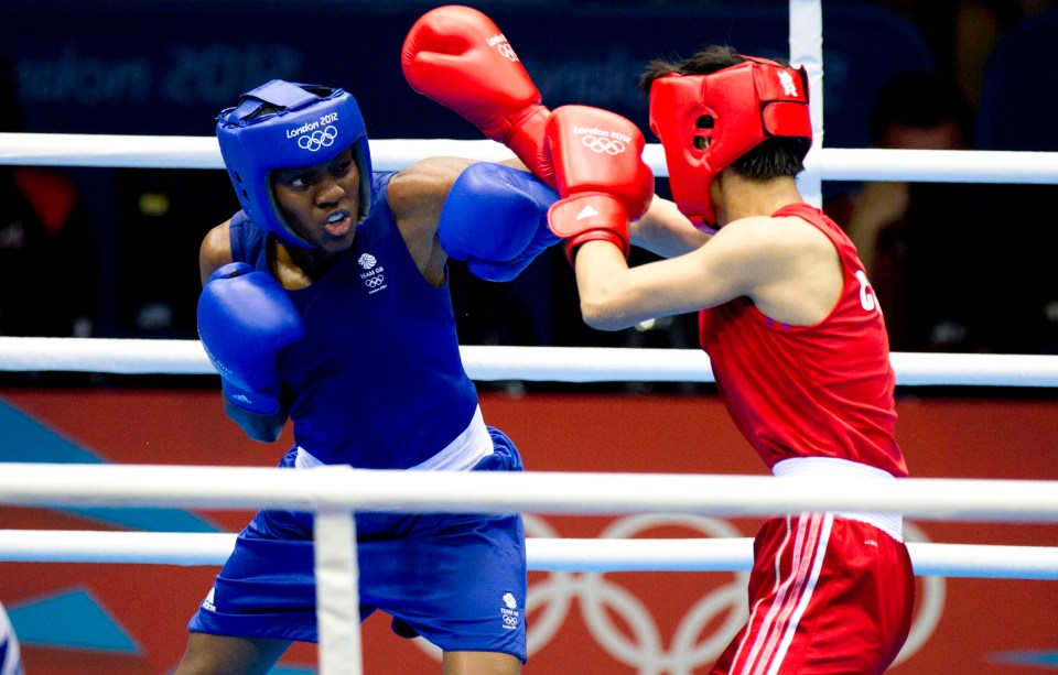 two boxers in a ring with one wearing a helmet that says london 2012