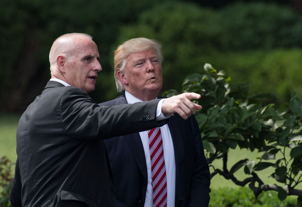 Donald Trump listens to Director of Oval Office Operations Keith Schiller at the White House