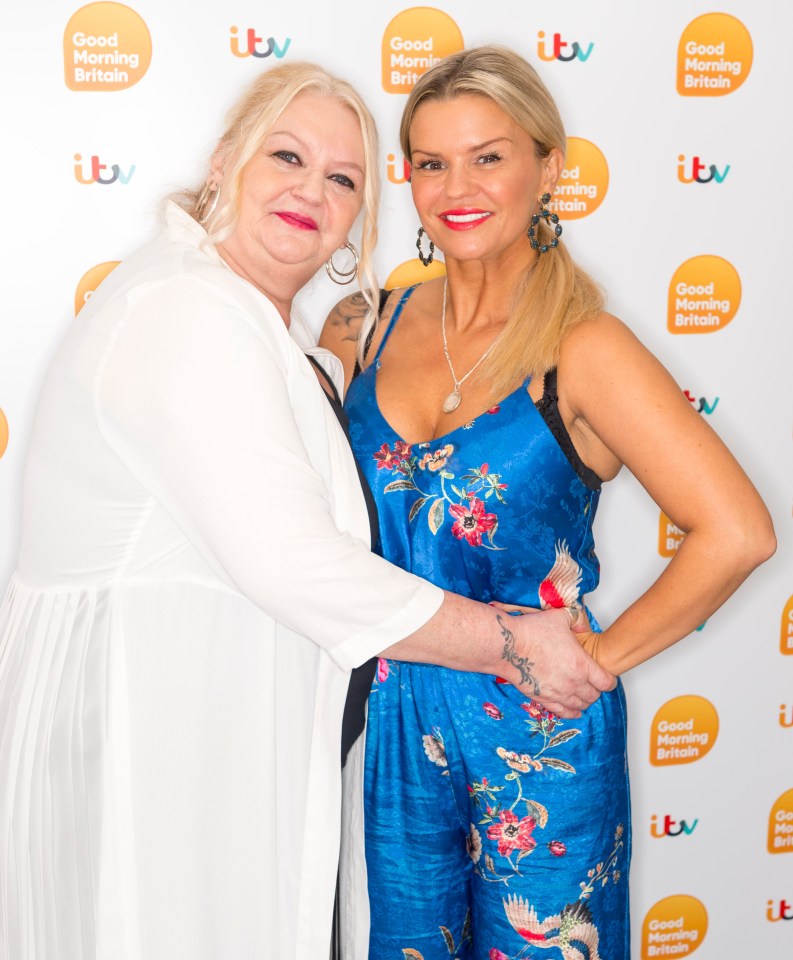 two women are posing for a picture in front of a wall that says good morning britain