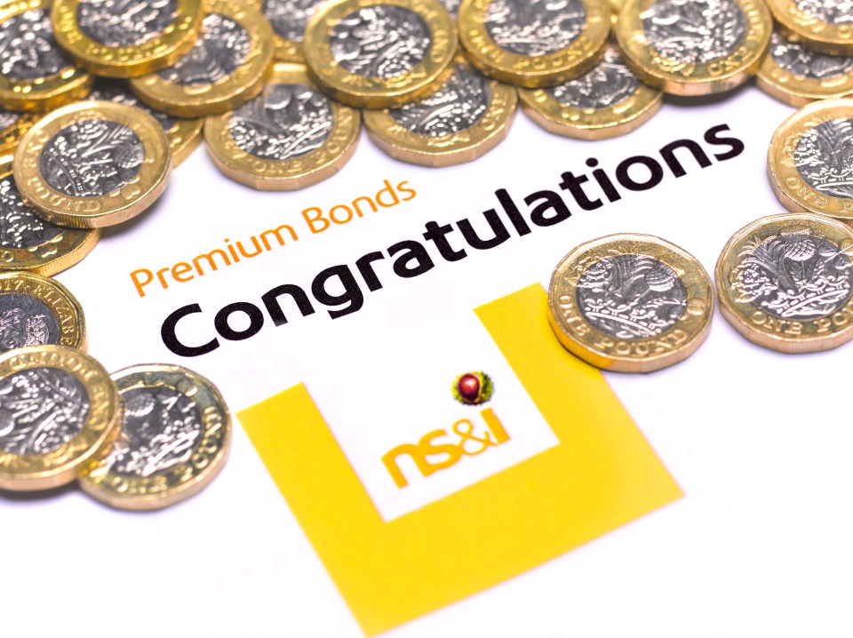 a congratulations card for premium bonds is surrounded by gold coins