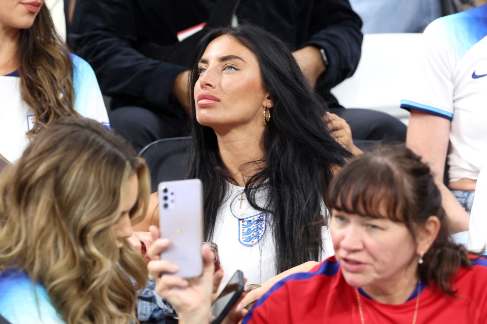 a woman taking a picture of another woman with an iphone