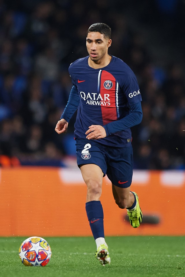 a soccer player wearing a qatar airways jersey runs with the ball