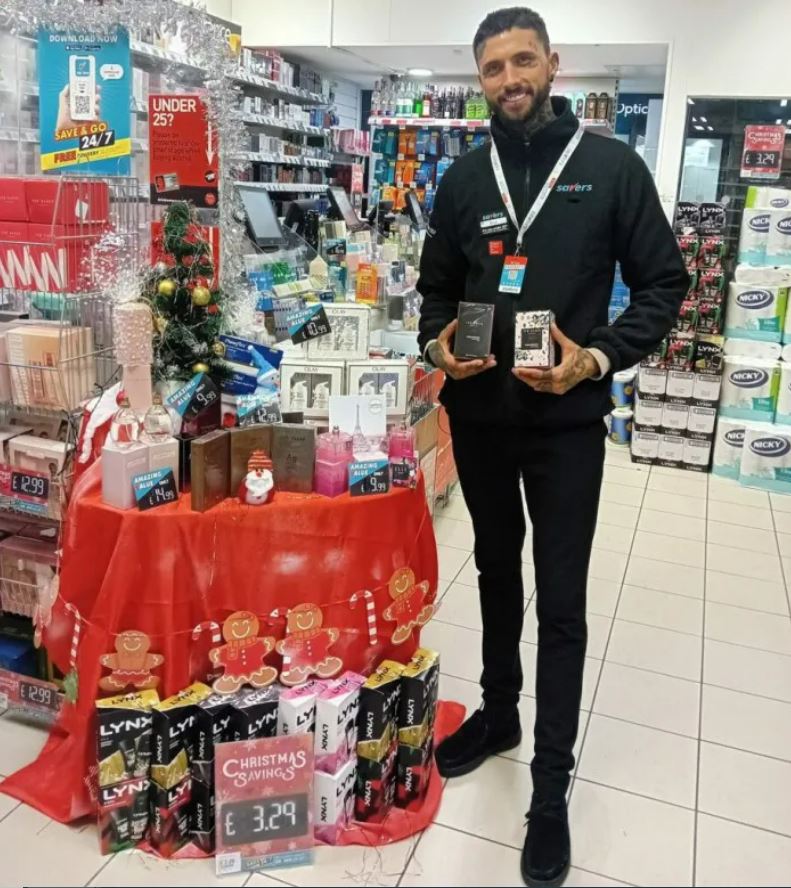 a man stands in front of a display of lynx products