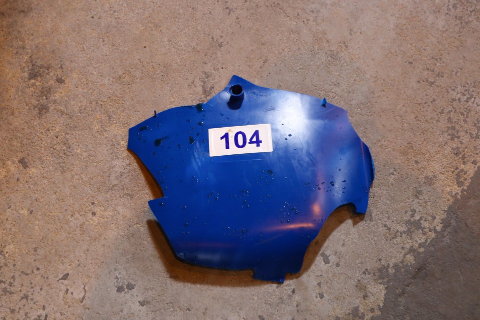 a blue piece of plastic with the number 104 on it