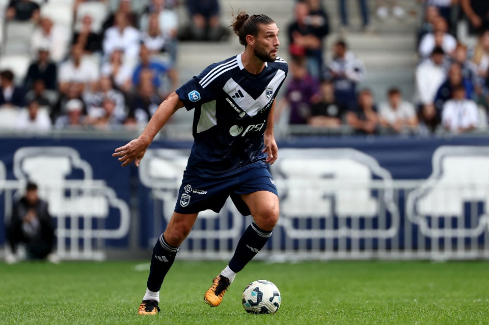 a soccer player wearing a jersey that says adidas on it