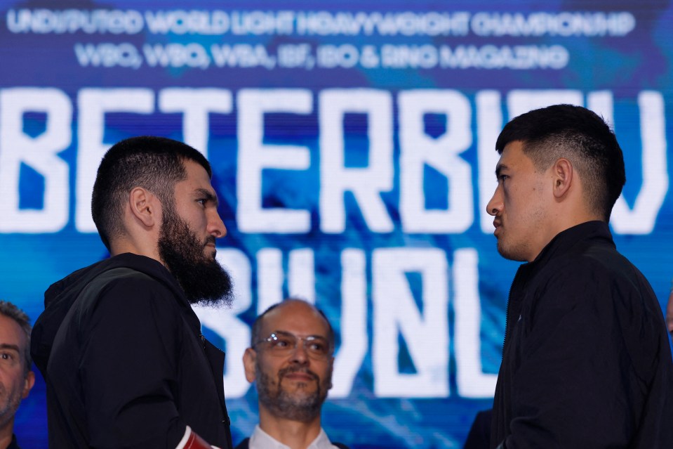 two men are facing each other in front of a sign that says betterbitv