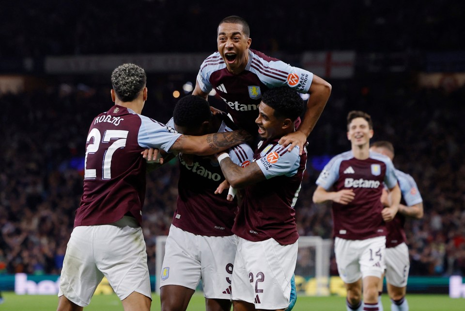 a group of soccer players with one wearing the number 27