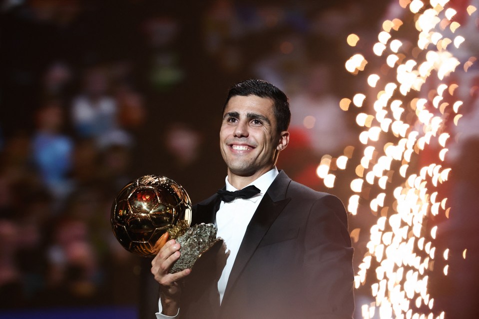 a man in a tuxedo is holding a soccer ball