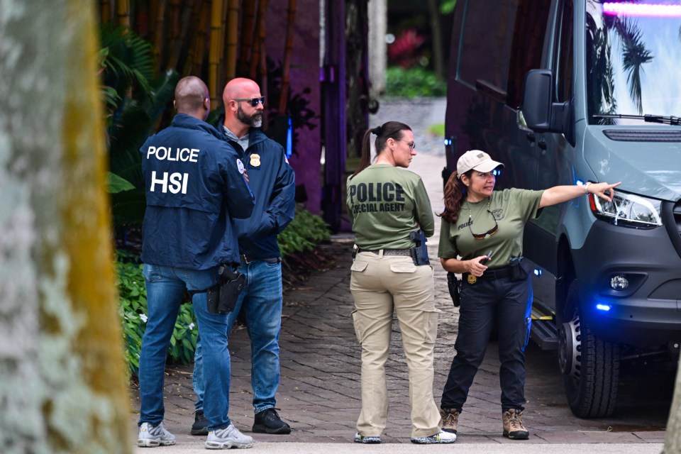 a group of police officers standing in front of a van