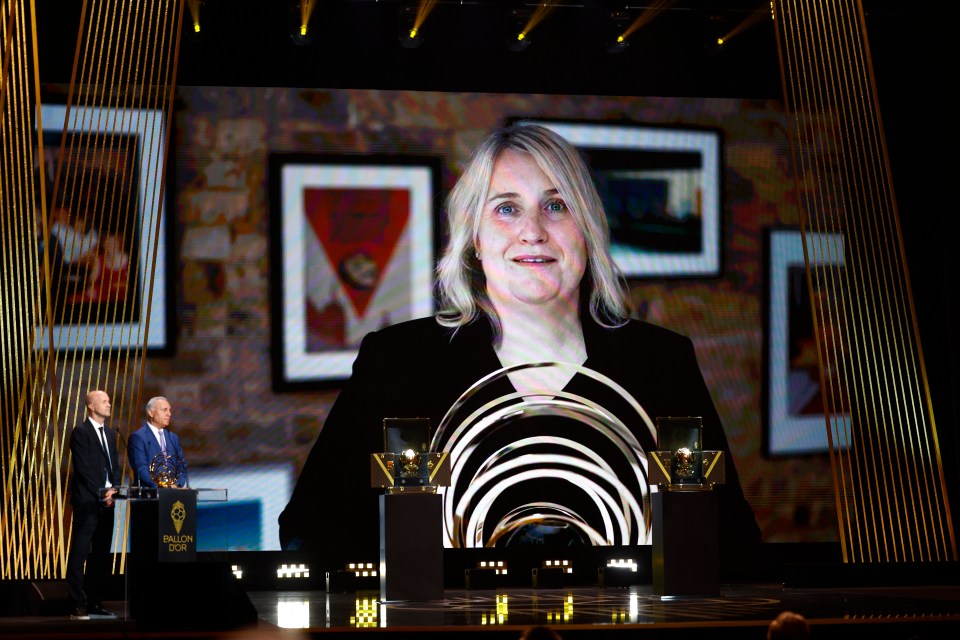 a woman is on a large screen at a trophy ceremony