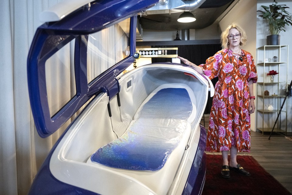 Fiona Stewart, co-president of Last Resort, stands beside the death capsule